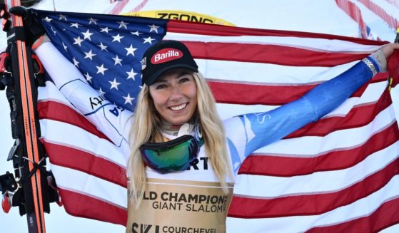 Mikaela Shiffrin celebrates with a U.S. flag after winning the women's giant slalom event of the FIS Alpine Ski World Championships in Meribel, French Alps, on Thursday.