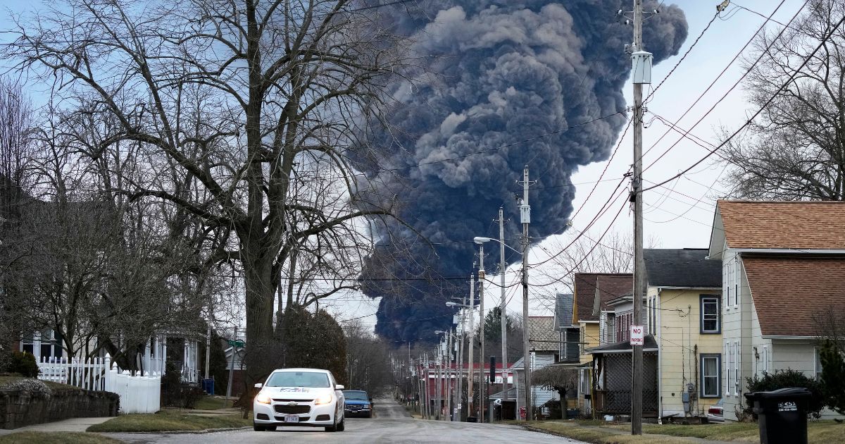 A black plume rises over East Palestine, Ohio, as a result of a controlled detonation of a portion of the derailed Norfolk Southern trains Monday.