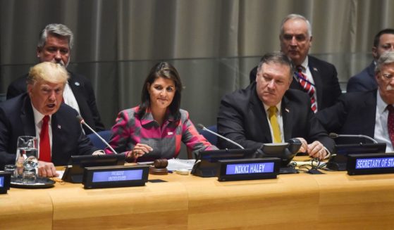 Then-President Donald Trump, left, talks as U.N. Ambassador Nikki Haley and other U.S. officials listen at the United Nations in New York on Sept. 24, 2018.