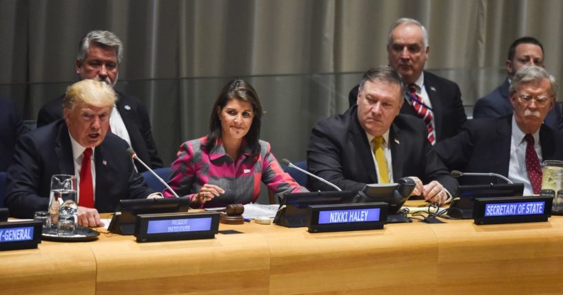 Then-President Donald Trump, left, talks as U.N. Ambassador Nikki Haley and other U.S. officials listen at the United Nations in New York on Sept. 24, 2018.