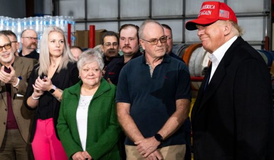Former President Donald Trump smiles before speaking at the East Palestine Fire Department station during his visit to East Palestine, Ohio, on Wednesday.
