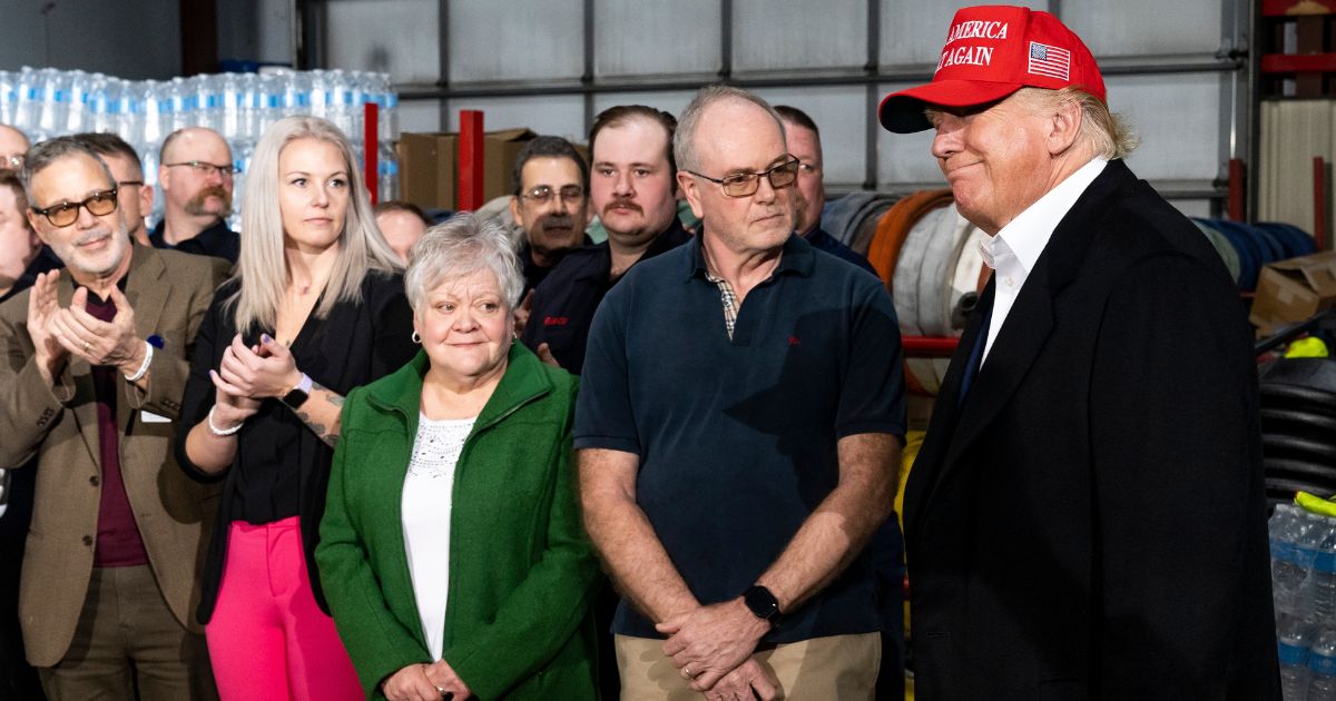 Former President Donald Trump smiles before speaking at the East Palestine Fire Department station during his visit to East Palestine, Ohio, on Wednesday.