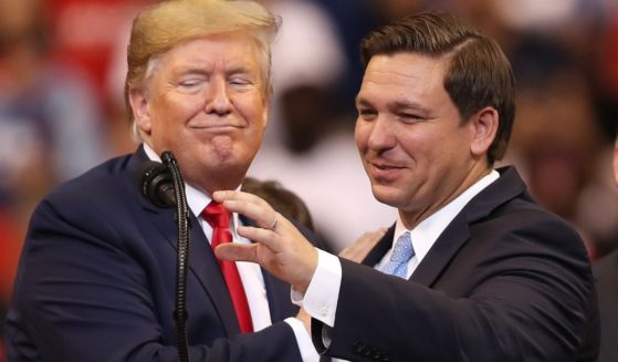 Then-President Donald Trump, left, and Florida Gov. Ron DeSantis take the stage together during a campaign rally in Sunrise, Florida, on Nov. 26, 2019.