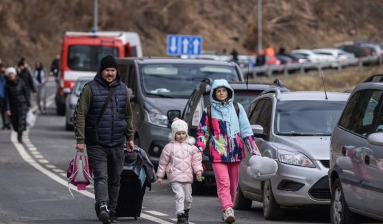 Refugees from Ukraine flee the country and make their way into Poland after passing through a checkpoint in Kroscienko, Poland, on Feb. 27, 2022.