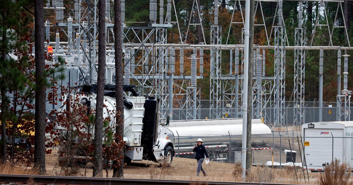 Workers work on equipment at an electrical substation in North Carolina