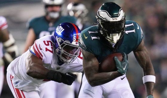 A.J. Brown #11 of the Philadelphia Eagles runs with the ball against Jarrad Davis #57 of the New York Giants during the NFC Divisional Playoff game at Lincoln Financial Field on January 21, 2023 in Philadelphia.