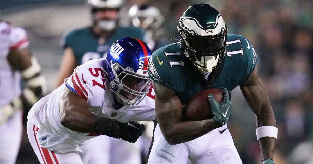 A.J. Brown #11 of the Philadelphia Eagles runs with the ball against Jarrad Davis #57 of the New York Giants during the NFC Divisional Playoff game at Lincoln Financial Field on January 21, 2023 in Philadelphia.