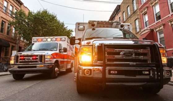 Two ambulances are seen in the above stock image.
