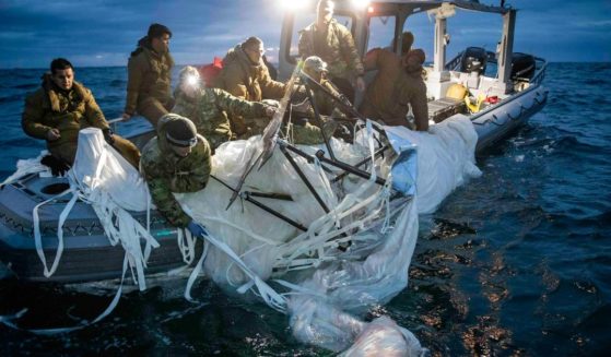 This image provided by the U.S. Navy shows sailors assigned to Explosive Ordnance Disposal Group 2 recovering a high-altitude surveillance balloon off the coast of Myrtle Beach, South Carolina, on Sunday.