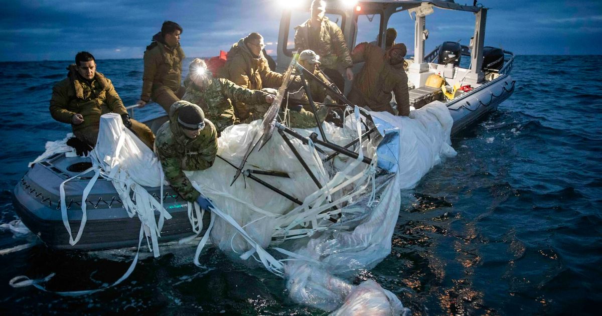In this photo provided by the U.S. Navy, sailors assigned to Explosive Ordnance Disposal Group 2 recover a high-altitude surveillance balloon off the coast of Myrtle Beach, South Carolina, on Feb. 5.