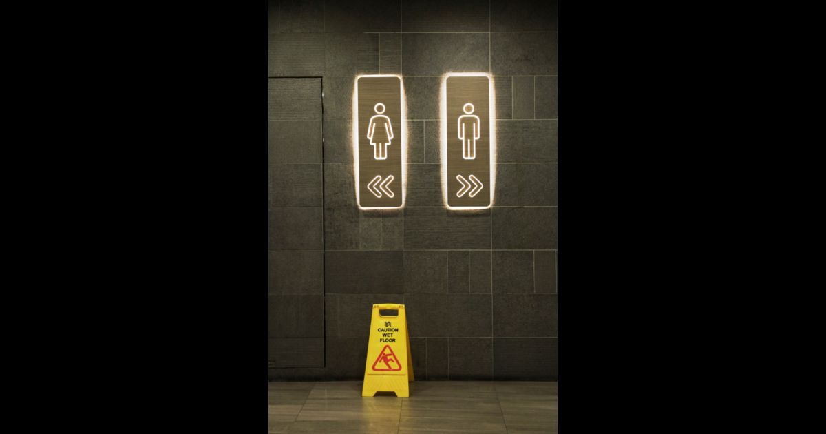 This stock image shows a pair of signs denoting a male and female bathroom.
