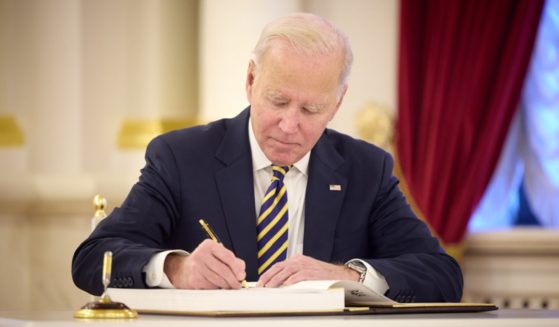 President Joe Biden signs a guest book during a meeting Monday in Kyiv with Ukraine President Volodymyr Zelenskyy.
