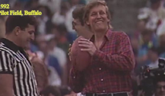 Then-private citizen/celebrity Donald Trump prepares to throw a football at a 1992 charity event.