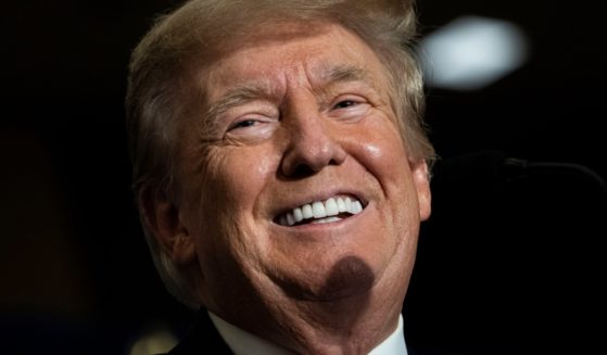 Former President Donald Trump, laughs in a file photo from the America First Agenda Summit in Washington in July.