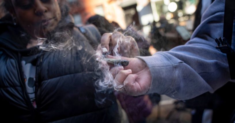 People smoke cannabis outside the Smacked "pop up" cannabis dispensary location, Jan. 24 in New York.