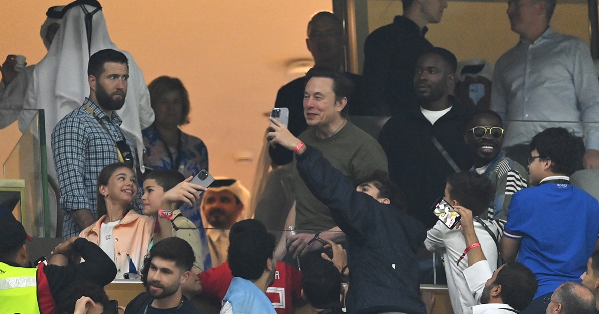 Twitter CEO Elon Musk is pictured mugging for a camera with fellow fans at the World Cup Final in December in Lusail City, Qatar.
