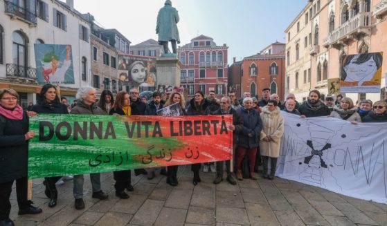 Iranian Democrats hold up banners in protest against Iranian regime on February 2, 2023 in Venice, Italy.