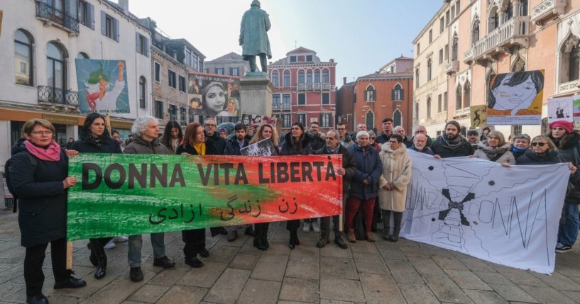Iranian Democrats hold up banners in protest against Iranian regime on February 2, 2023 in Venice, Italy.