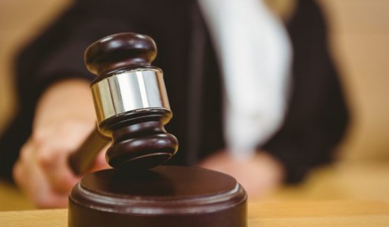 A judge bangs a gavel in the above stock image.