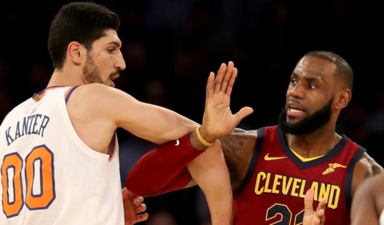 Enes Kanter #00 of the New York Knicks and LeBron James #23 of the Cleveland Cavaliers fight for position at Madison Square Garden on November 13, 2017 in New York City.
