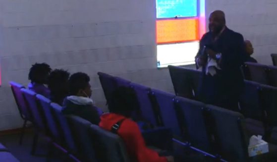 The pastor confronts four young men at All Creation Northview Holiness Family Church in Ferguson, Missouri.