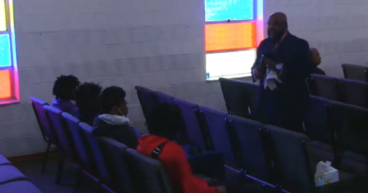 The pastor confronts four young men at All Creation Northview Holiness Family Church in Ferguson, Missouri.