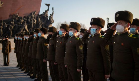 Soldiers of the Korean People's Internal Security Forces (KPISF) pay their respects before the statues of late North Korean leaders Kim Il Sung and Kim Jong Il to mark the 75th anniversary of the founding of the Korean People's Army (KPA) at Mansu Hill in Pyongyang on February 8, 2023.
