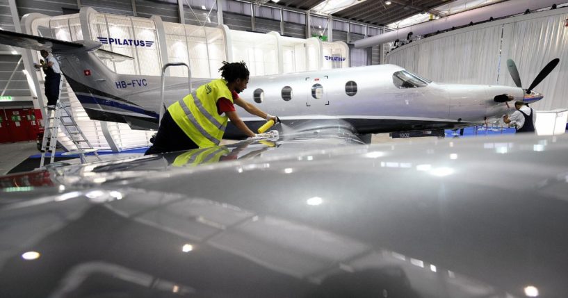 An employee cleans a PC-12 model of the Swiss aircraft manufacturer Pilatus during the press day of the 8th Annual European Business Aviation Convention & Exhibition (EBACE) on May 19, 2008 in Geneva's International Airport.