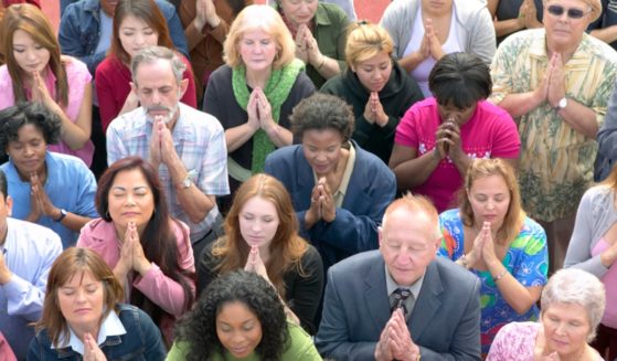 A group of people praying.