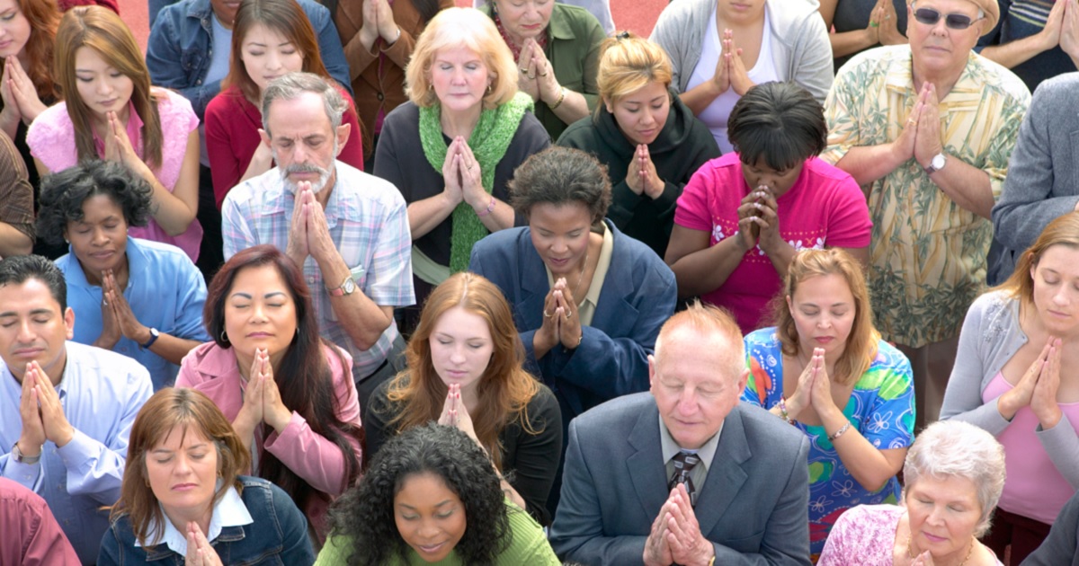 A group of people praying.
