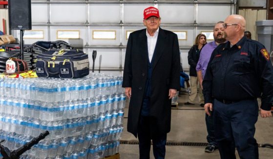 Former President Donald Trump stands next to a pallet of water before delivering remarks at the East Palestine Fire Department station on Wednesday in East Palestine, Ohio.