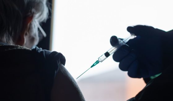 An elderly woman receives a vaccine in the above stock image.