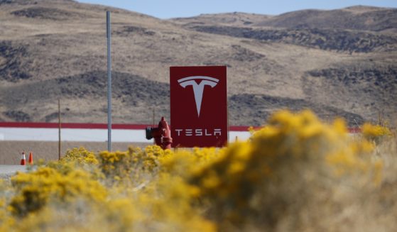 A sign marks the entrance to the Tesla Gigafactory in Sparks, Nevada, in this file photo from 2018. Tesla will get more than $330 million in tax breaks from Nevada to massively expand its vehicle battery facility east of Reno and add a new electric semi-truck factory.
