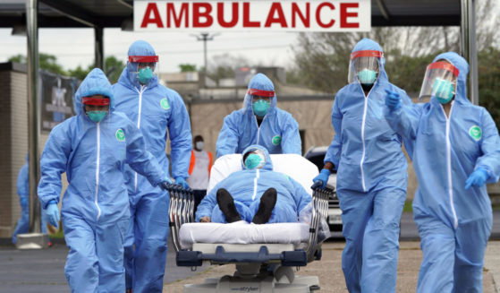 a medical team wheeling a man on a stretcher