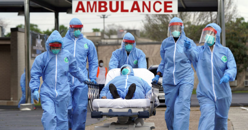 a medical team wheeling a man on a stretcher