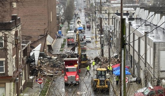 Emergency responders and heavy equipment are seen at the site of a deadly explosion at a chocolate factory in West Reading, Pennsylvania, Saturday, March 25.