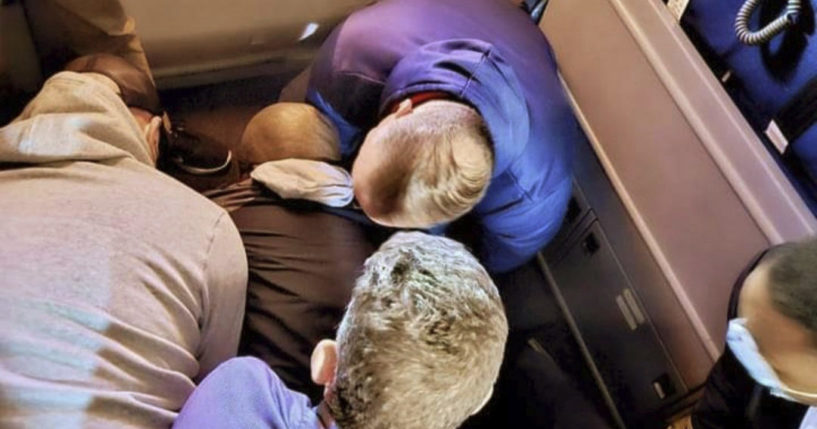 passengers holding down a violent suspect