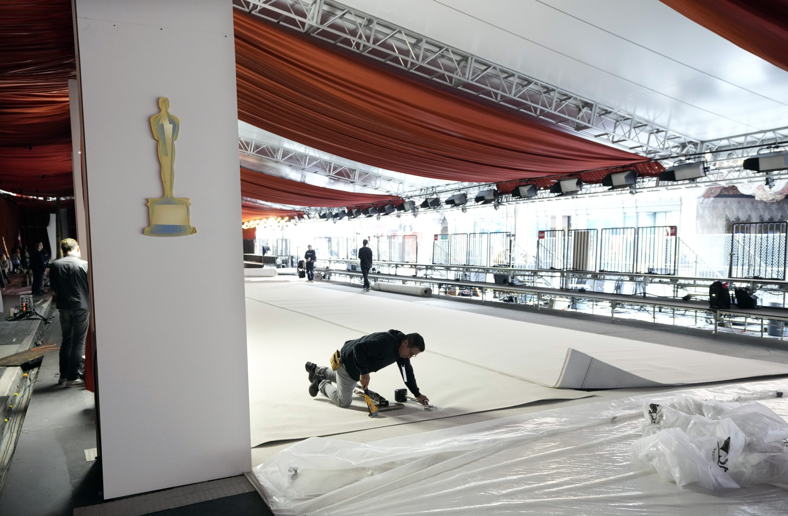 A crew member staples the carpet to the ground in preparation for Sunday's 95th Academy Awards in Los Angeles on Wednesday.