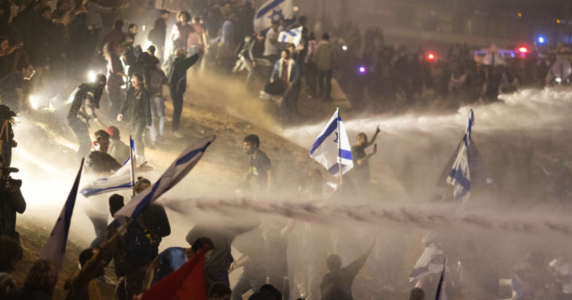 Israeli police use a water cannon to disperse demonstrators blocking a highway during a protest against plans by Prime Minister Benjamin Netanyahu's government to overhaul the judicial system in Tel Aviv, Israel, on Monday.