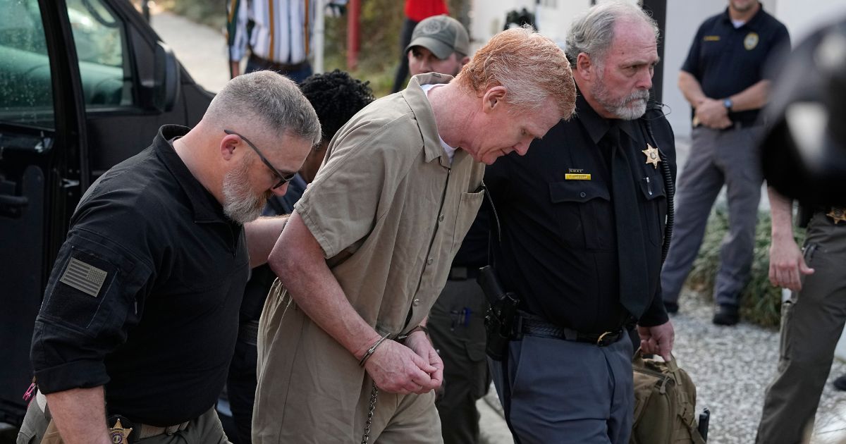 Alex Murdaugh, middle, is led into the Colleton County Courthouse to face sentencing in Walterboro, South Carolina, on Friday.