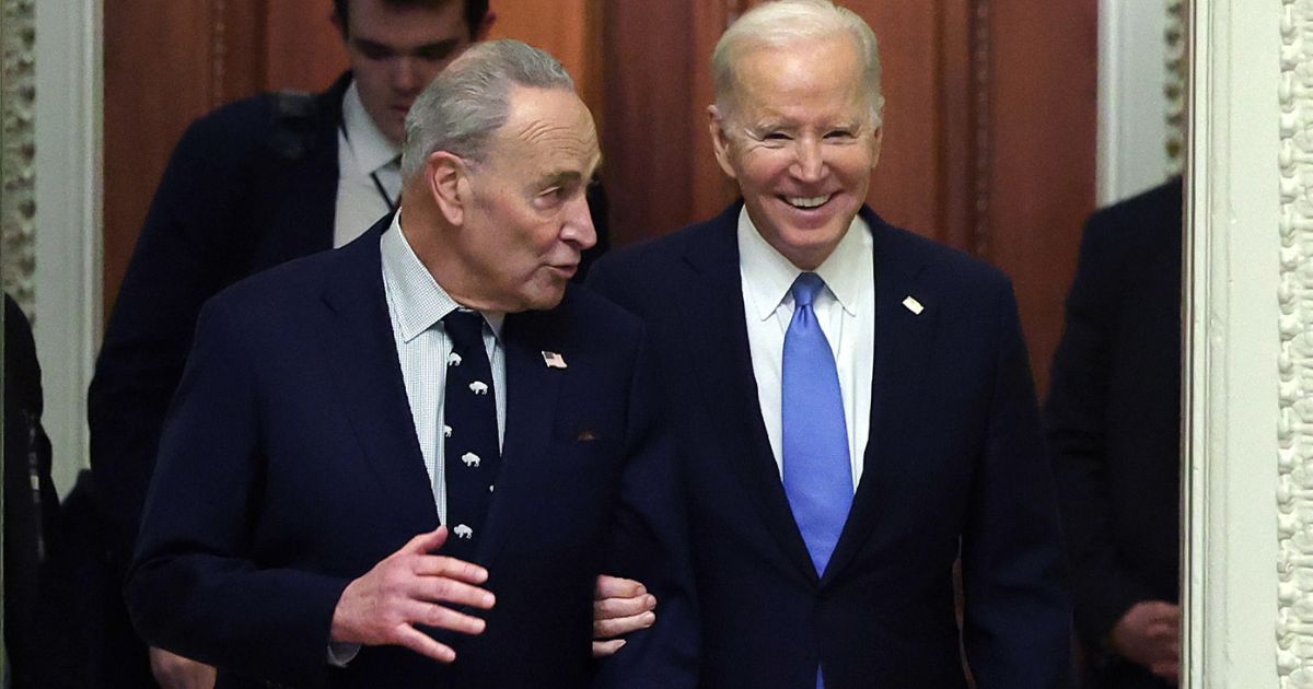 Senate Majority Leader Chuck Schumer, left, and President Joe Biden, right, walks through the U.S. Capitol in Washington, D.C., on Thursday.
