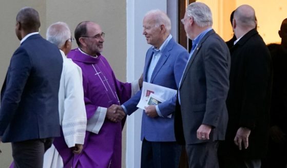 President Joe Biden greets a priest as he departs after attending Mass at St. Joseph on the Brandywine Catholic Church in Wilmington, Delaware, on Saturday.