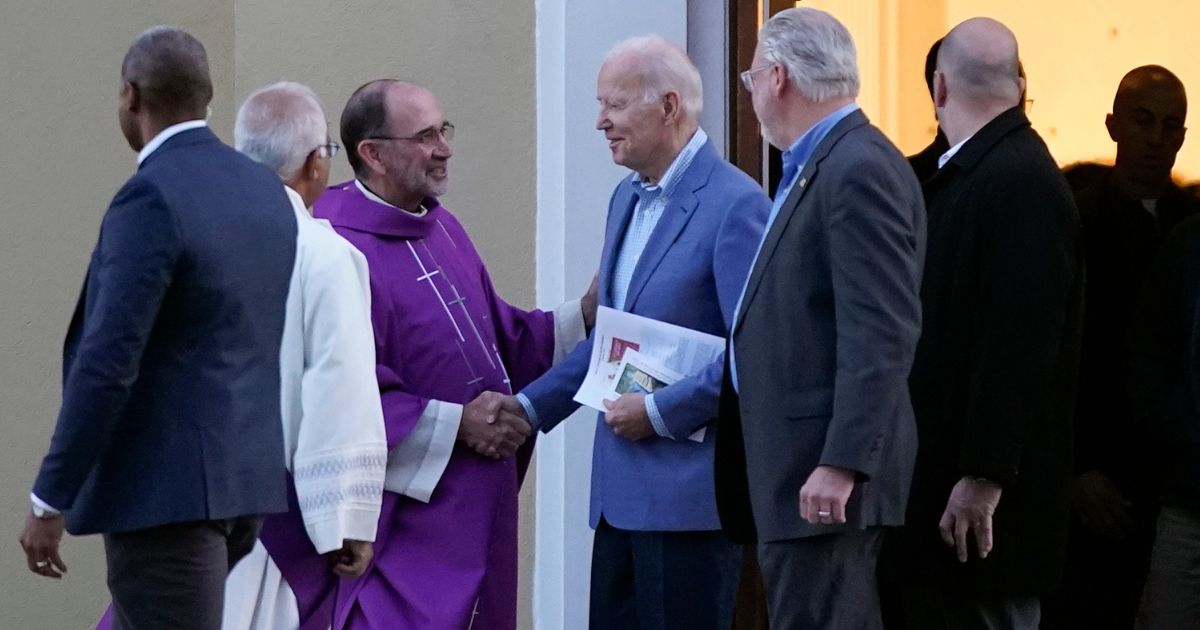 President Joe Biden greets a priest as he departs after attending Mass at St. Joseph on the Brandywine Catholic Church in Wilmington, Delaware, on Saturday.