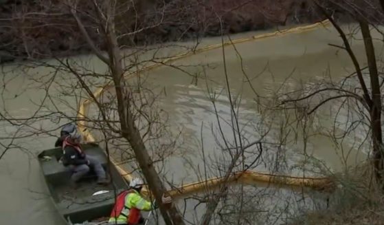 A clean up crew works in the Otter Creek, a tributary of the Delaware River, in Pennsylvania after chemicals leaked into the water on Friday.