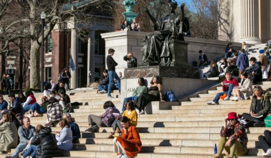 students relaxing on the front steps of Low Memorial Library on the Columbia University campus