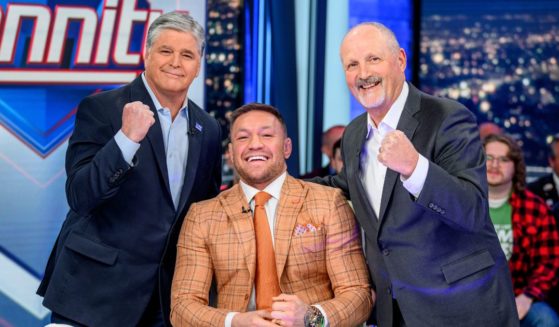 Sean Hannity, left, Conor McGregor, center, and Frank Siller, right, pose on the set of "Hannity" in New York City on Wednesday.