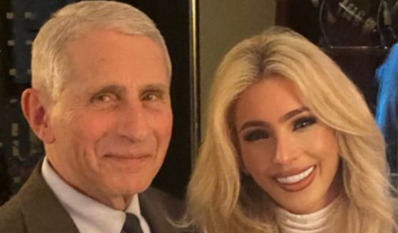 Melissa Rein Lively, right, stood for a photo with Dr. Anthony Fauci, left, who believed she was a fan of his, but her gesture in the photo tells a different story.