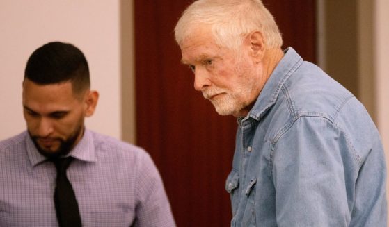 George Alan Kelly, right, walks over to his lawyer during his arraignment in Santa Cruz County Superior Court in Nogales, Arizona, on Monday.
