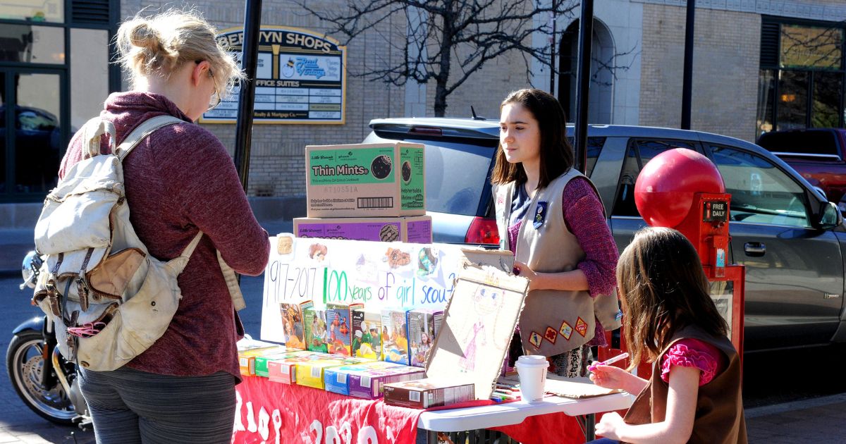 Molly Sheridan, left, and her sister Edie sell Girl Scout cookies in front of a Starbucks coffee shop in Chicago on Feb.19, 2017.