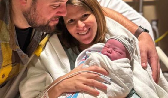 CNN anchor Kasie Hunt and her husband, Matthew Mario Rivera, hold their newborn daughter, Grey.